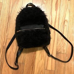 Faux leather, faux fur small backpack.